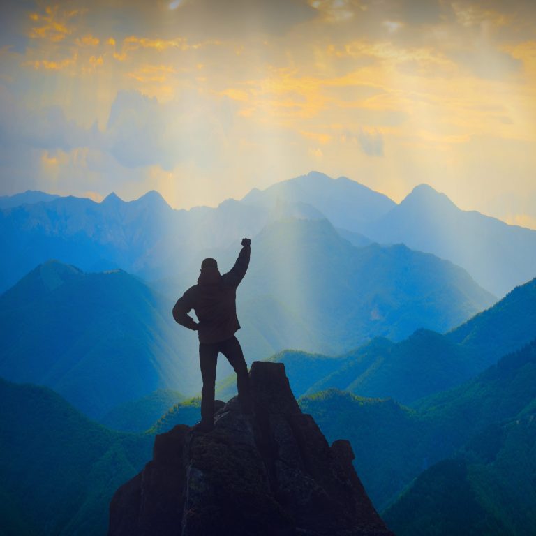 silhouette-on-mountain-peak-during-golden-hour-lig